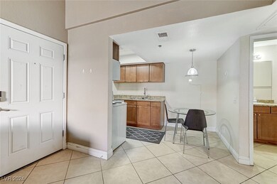 Kitchen with brown cabinets, visible vents, light