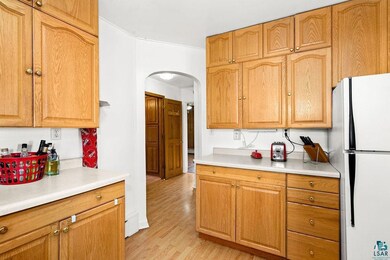 Kitchen featuring white fridge and oak cabinets