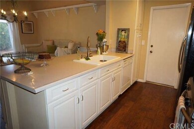 Another view of the kitchen and door to the garage. 