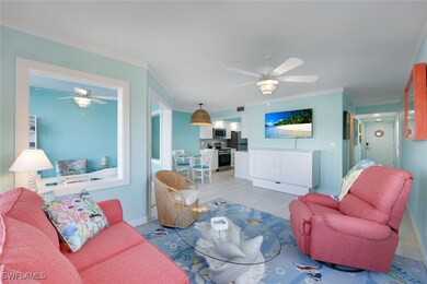 Living room featuring crown molding, ceiling fan,