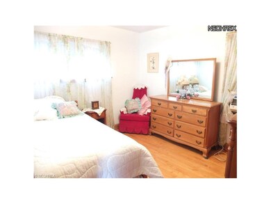 Bedroom 1 with hardwood floors.