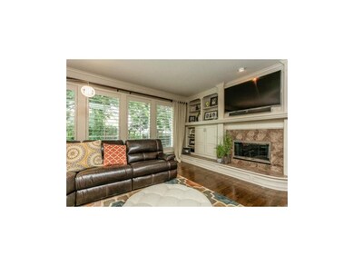 Great room with fireplace, plantation shutters and