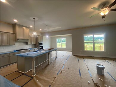 Kitchen featuring a sink, gray cabinets, tasteful backsplash, ornamental molding, and gas stovetop