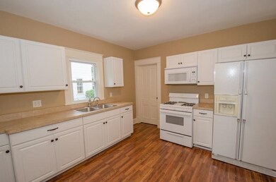Kitchen with laminate floors, newer appliances and