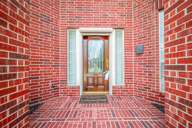 Welcoming front entrance with a rich red brick ext