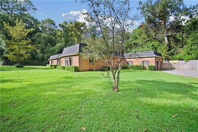 View of front of property with concrete driveway, brick siding, and an attached garage