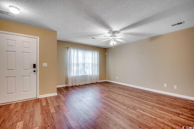 Foyer with visible vents, wood finished floors, an