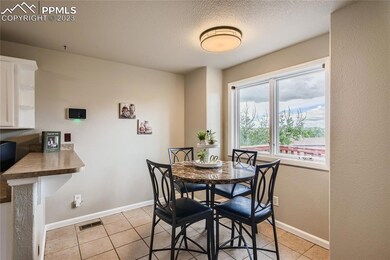 The adjacent dining area offers a warm and intimate setting for family meals.