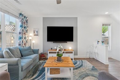 Living room featuring wood finished floors and a ceiling fan