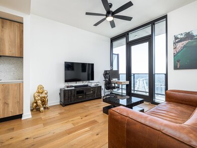 Living area with a ceiling fan, floor to ceiling 