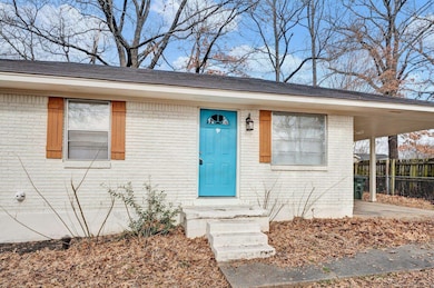 Doorway to property with a carport