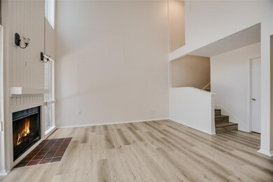 Unfurnished living room featuring wood finished f