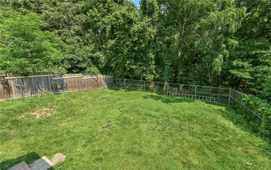 Completely Fenced Backyard space backed to the woods offering plenty of privacy.