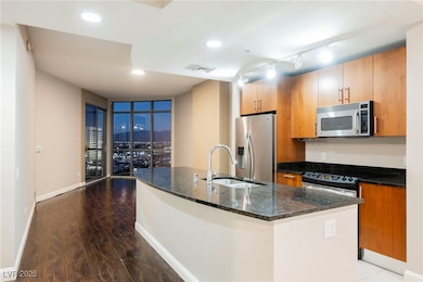 Kitchen with dark stone countertops, visible vents