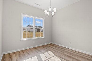 Spare room with an inviting chandelier and light w