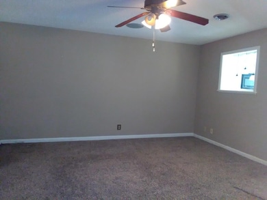 spacious living room looking into kitchen