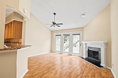 Unfurnished living room featuring vaulted ceiling,