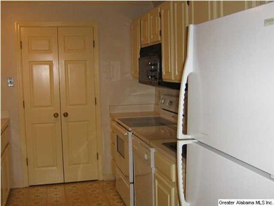 Washer and dryer are hidden behind bifold doors in