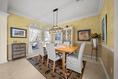 Elegant formal dining is located off of the foyer and features extended millwork including crown molding and chair rail.
