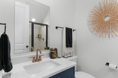 Full bathroom with vanity, toilet, and a tile sho