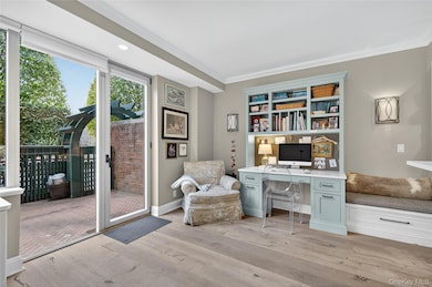 Office with ornamental molding, light wood-style floors, and recessed lighting