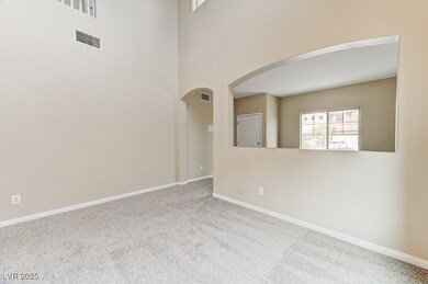 Unfurnished room featuring carpet flooring, arched