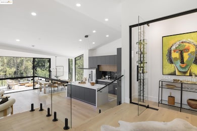 Kitchen with modern cabinets, light wood-style flooring, recessed lighting, gray cabinets, and a center island