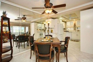 Mirrored Dinning Room Wall with ceiling fan.   