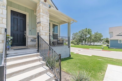 View of exterior entry with stone siding and a la