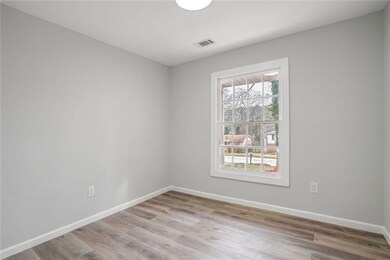 Spare room with wood finished floors and baseboards