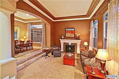 The step-down living room has a dramatic fireplace