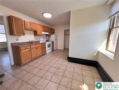 spacious kitchen features an eat-in area.