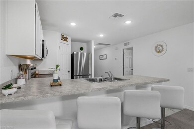 Kitchen with a kitchen bar, stainless steel applia