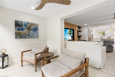 Sitting room with ceiling fan and light wood-type 