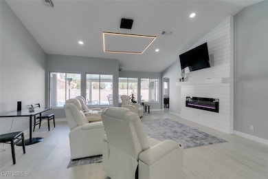 Living room featuring baseboards, vaulted ceiling,