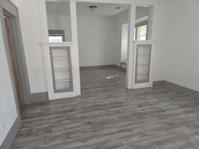 Unfurnished room with dark hardwood / wood-style f