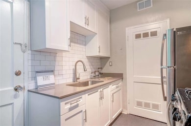 Kitchen with backsplash, stainless steel refrigera