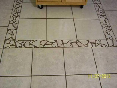 Kitchen. Detail of repaired tile.