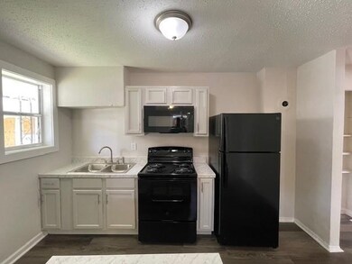 Kitchen with dark hardwood / wood-style flooring, 