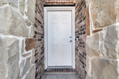 This photo shows a front entryway featuring a whit
