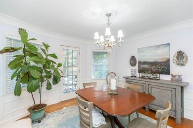 Dining room with hardwood floors with large bay wi