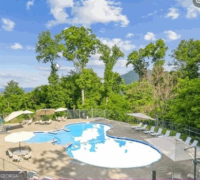 Pool featuring fence and a patio