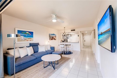 Tiled living room with ceiling fan with notable ch