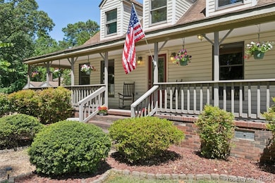 View of exterior entry with a porch