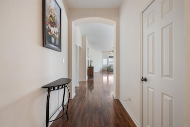 Hallway with arched walkways and dark wood finish