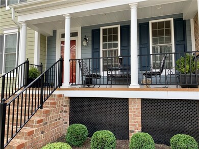 Relaxing Front Porch with few steps up to entry.
