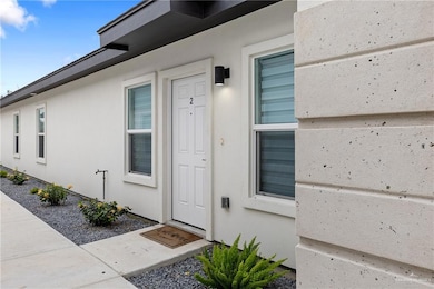 Property entrance featuring stucco siding
