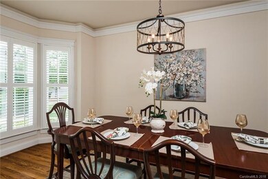 Natural light flows from the bay window into the l