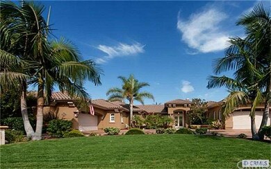 The beautiful home is accented by lush landscaping