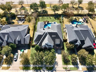 Overhead view of the home showing an extended driveway, plenty of mature oak trees in the front yard, no rear neighbors.  Also, note the large, well kept homes on either side as well.